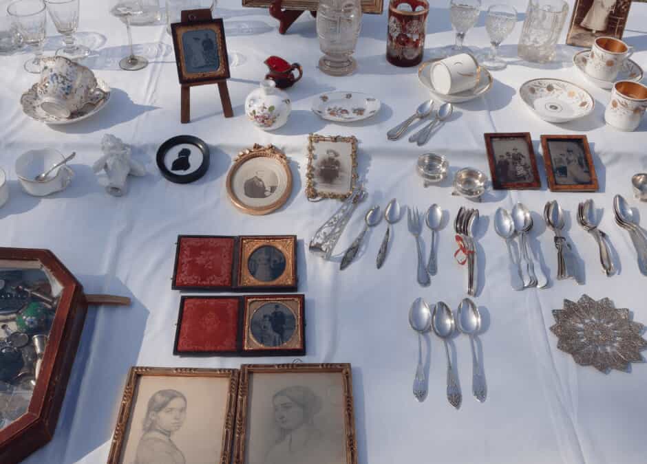 silverware and antiques laid out on a table