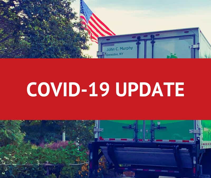 Back of a Mayflower moving truck with a red graphic over it that says "COVID-19 UPDATE"