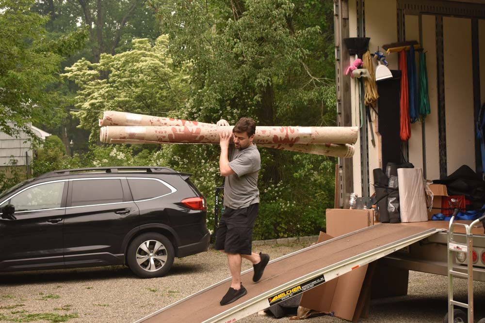 personnel carrying a carpet