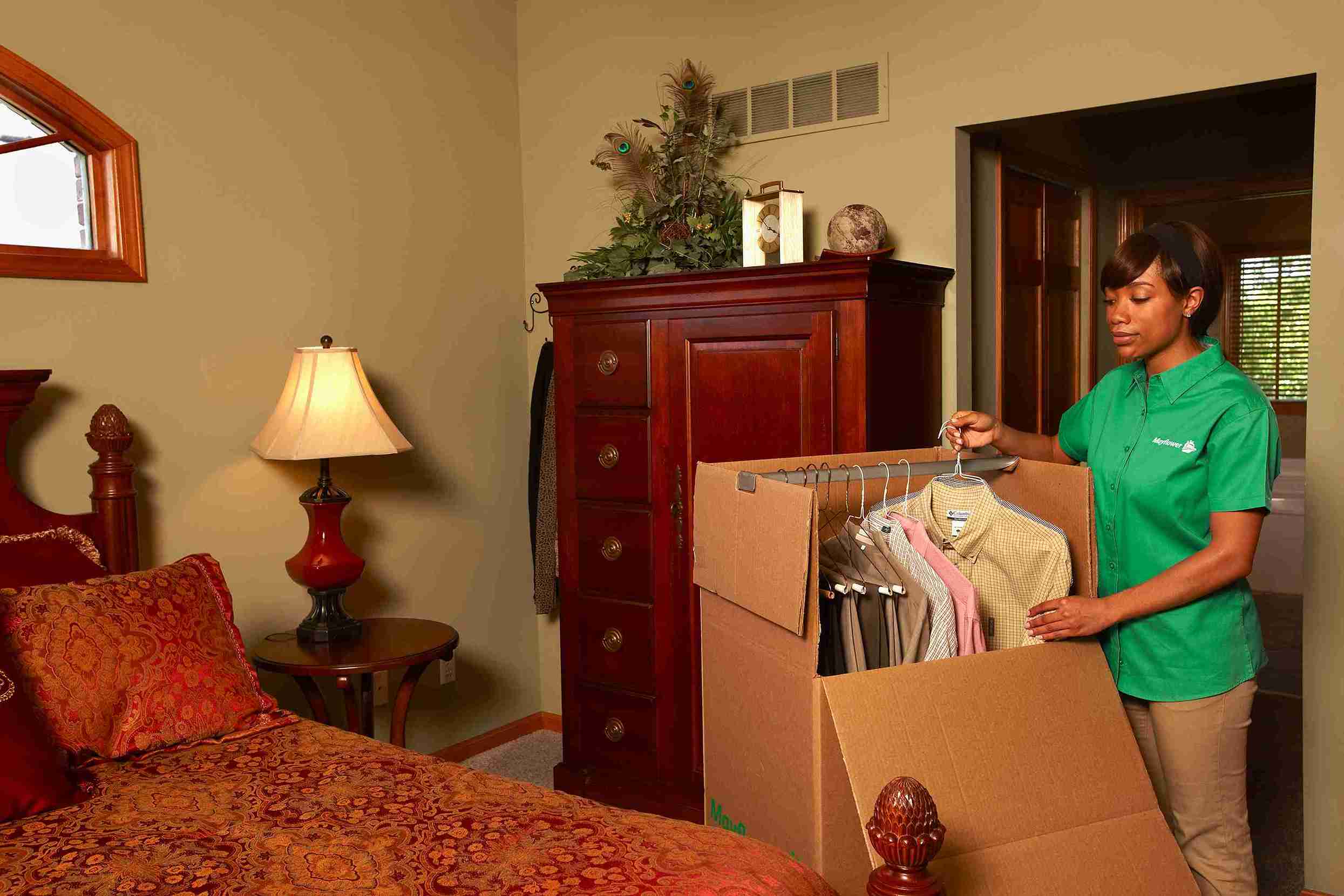 woman packing things in the bedroom