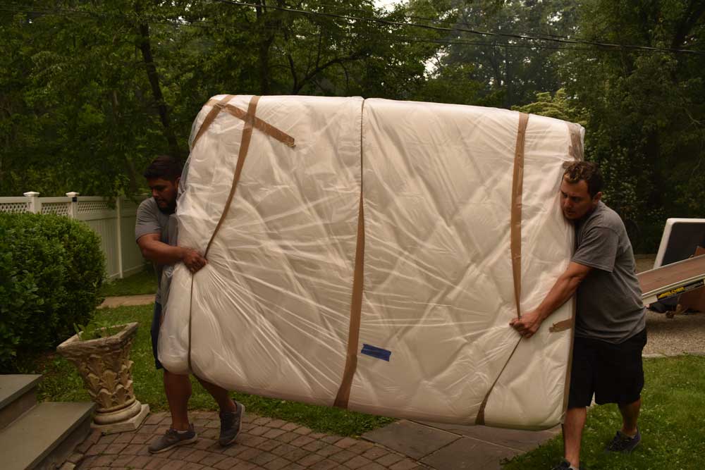 Two guy moving mattress