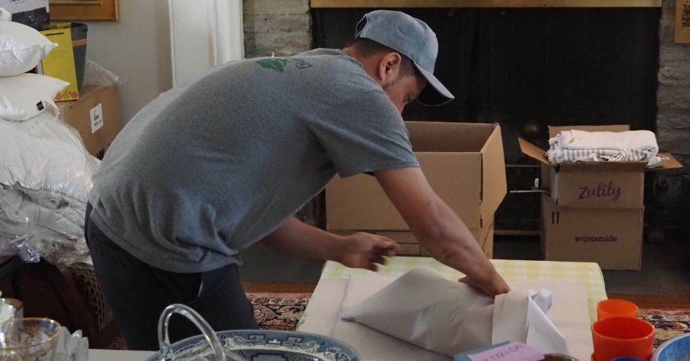 A mover wraps a fragile item for a move in Hartford.