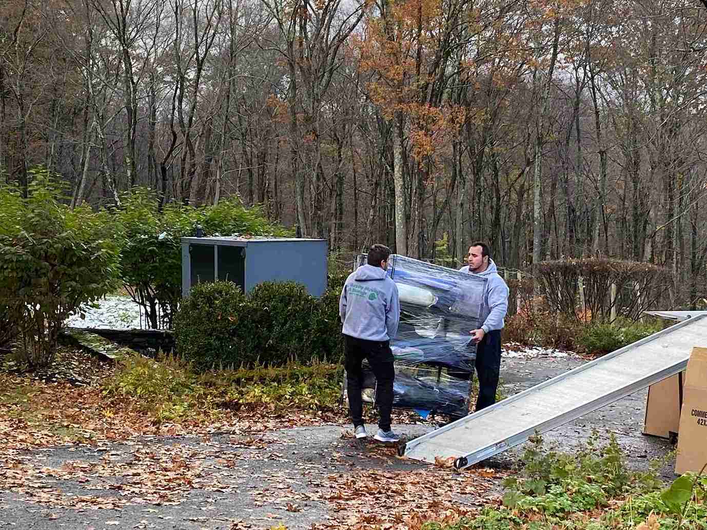 2 persons moving the package