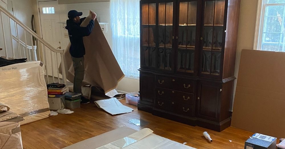 Mover wraps china cabinet in blanket