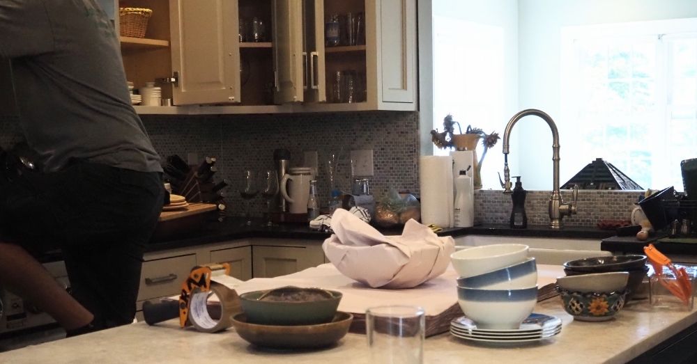 Mover packing kitchen bowls and dishes; do movers pack for you.