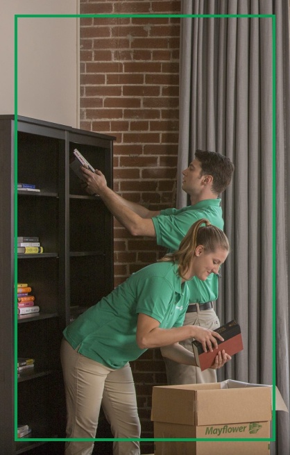 Movers preparing box packages for books