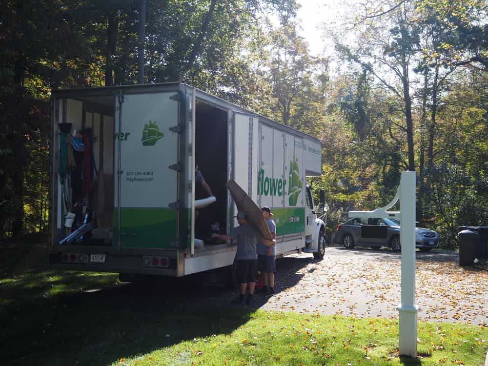 Movers unloading furniture and boxes