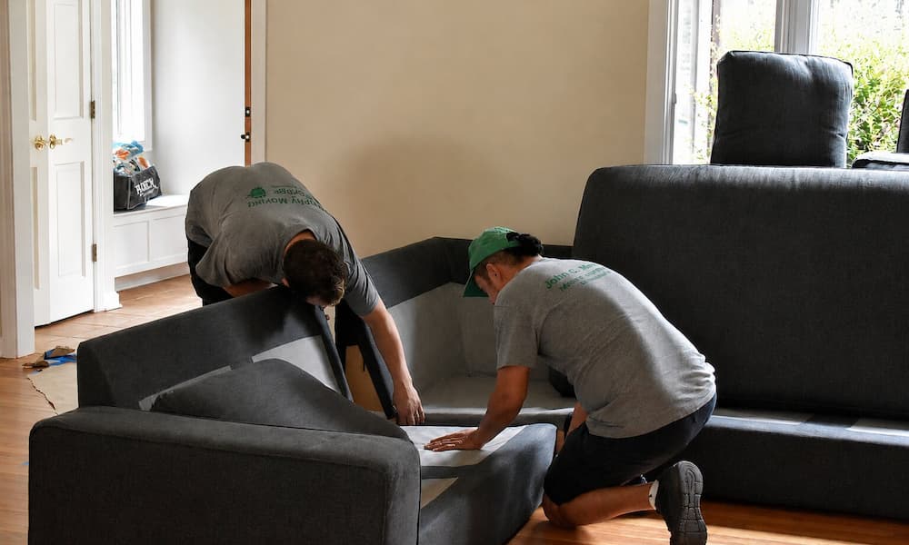 Movers assembling a sectional sofa during a single-item move