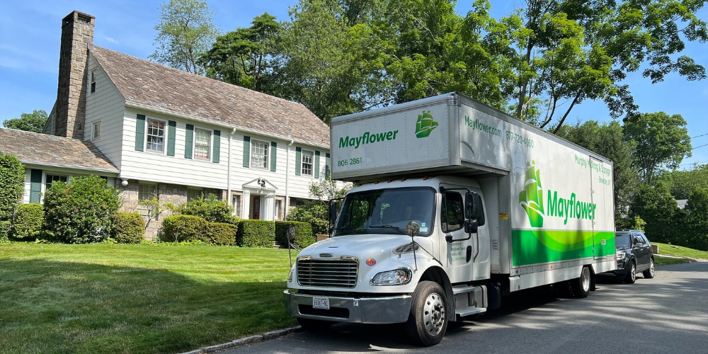A large white Mayflower moving truck