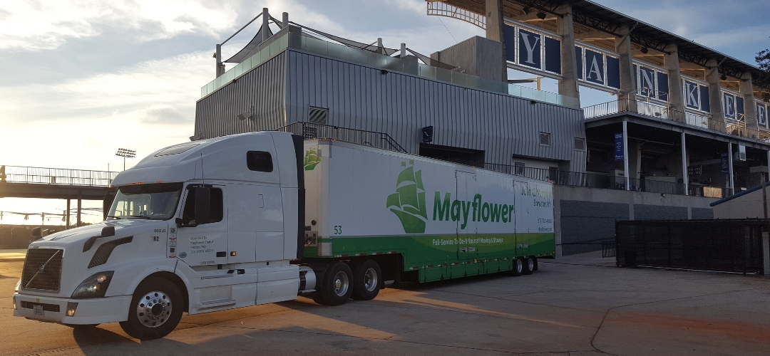 A white Mayflower semi-truck parked