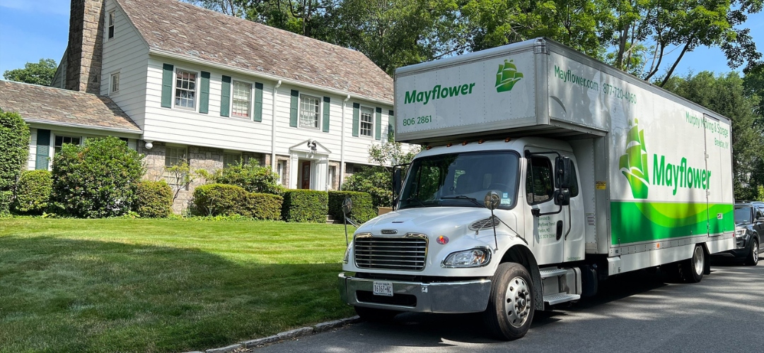 white Mayflower moving truck parked on the street