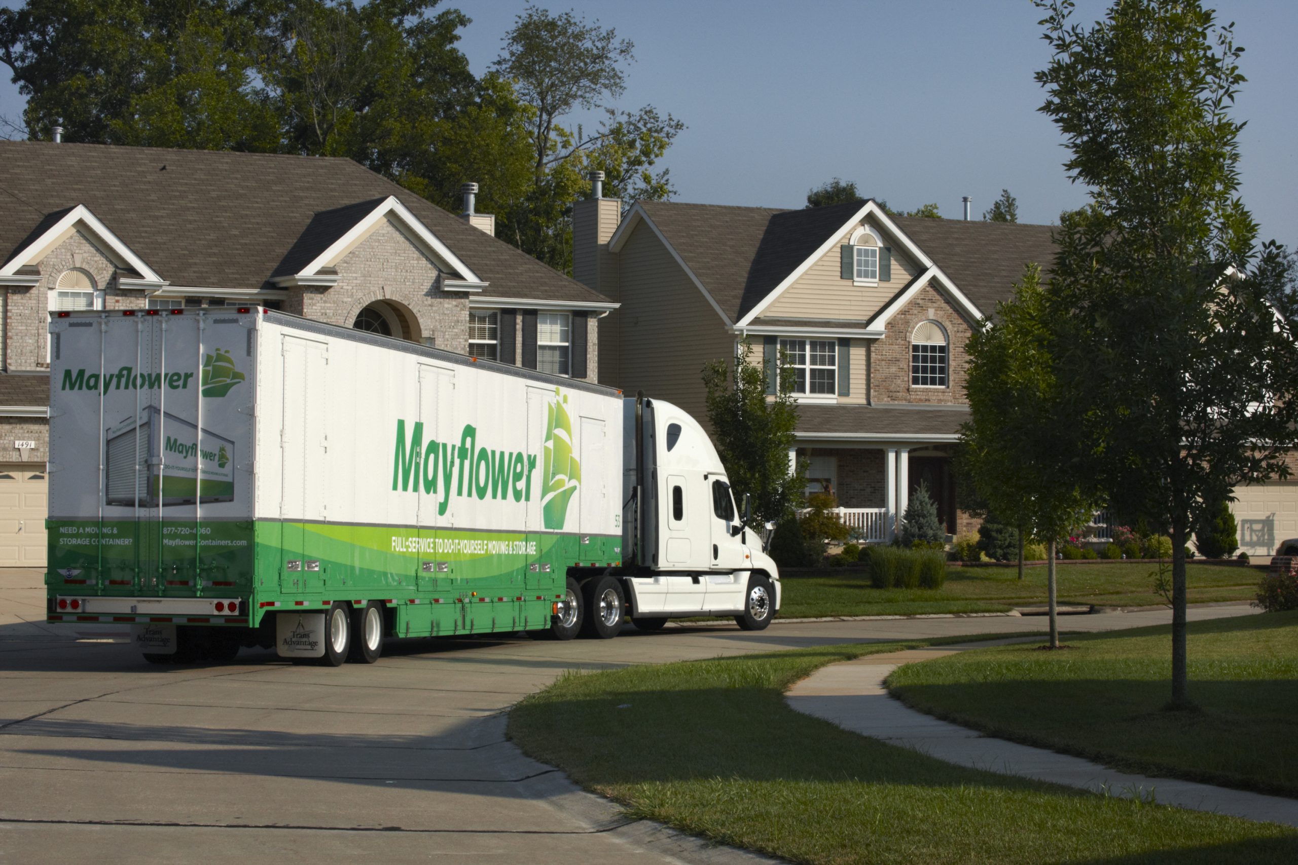 Mayflower moving truck parked on a residential street
