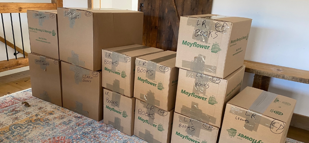 A stack of taped cardboard moving boxes