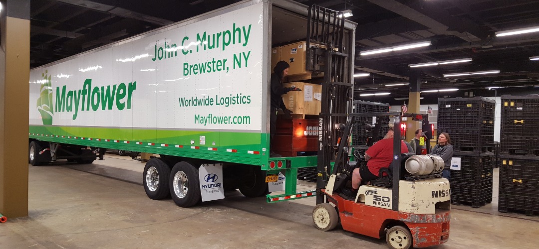 forklift operator loads cargo boxes