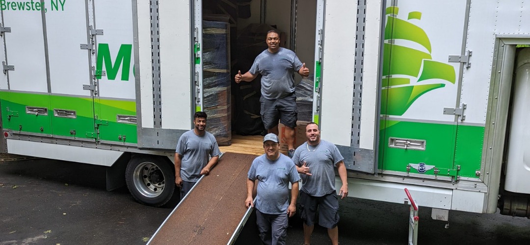 Four smiling movers