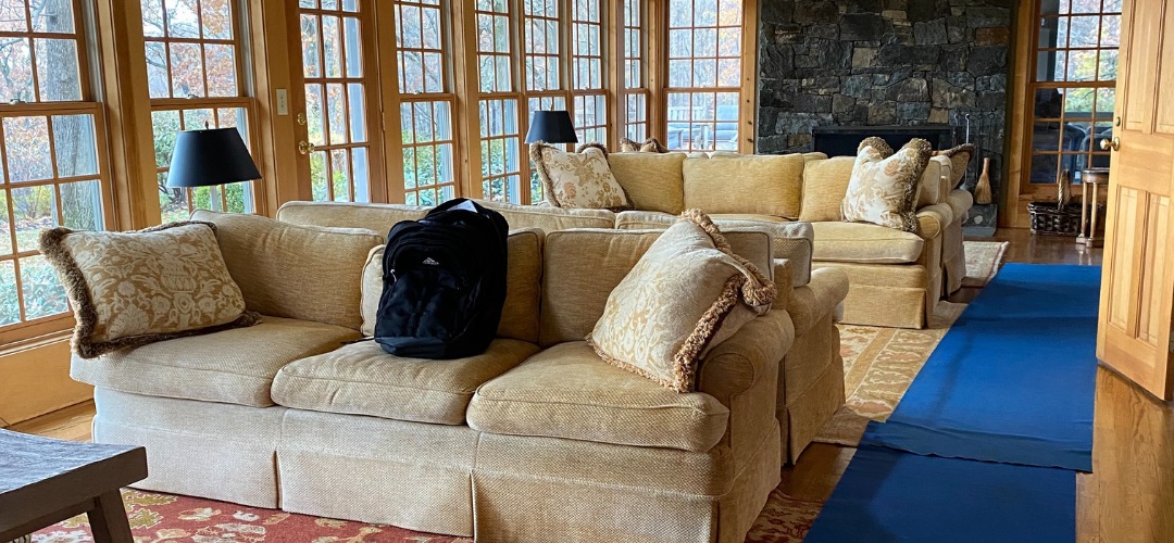 sunroom filled with beige sofas protected by floor runners