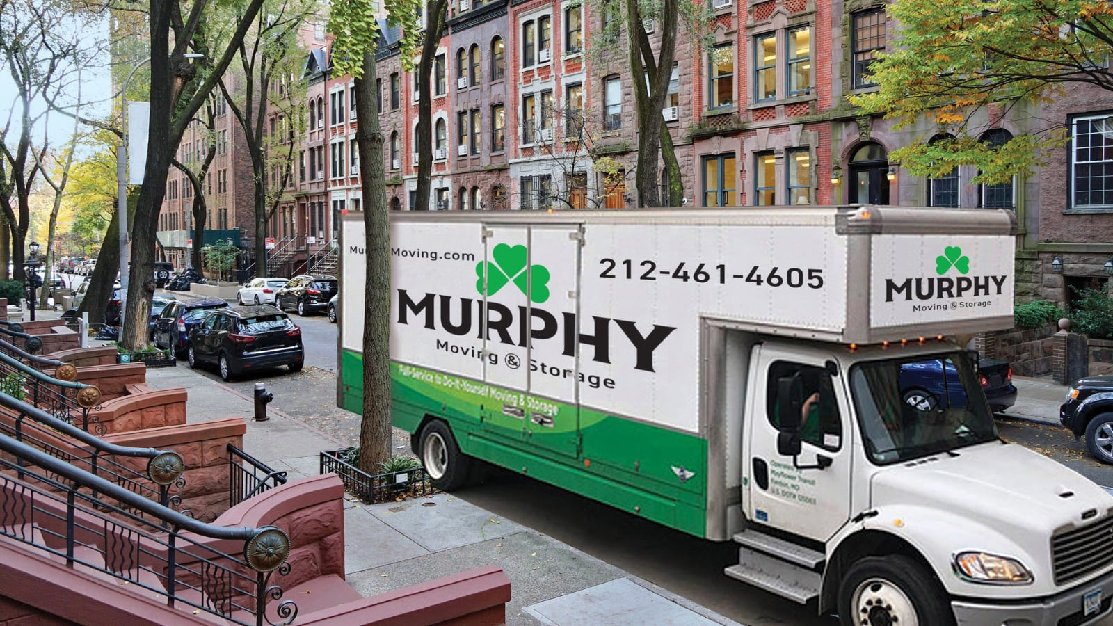 A moving truck parked on a city street, ready for loading or unloading belongings during a relocation process.